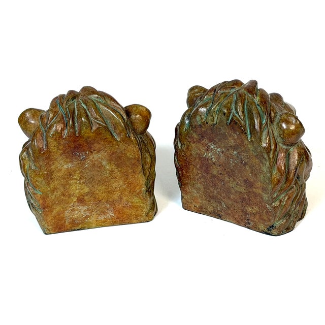 Pair of Regal Bronze Lion Head Bookends with Verdigris Patinated Highlights A striking pair of sculptural lion head...