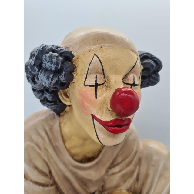 A unique, large sculpture depicting a seated circus clown, created by Filipino artist Jun Asilo in 1995. The sculpture...