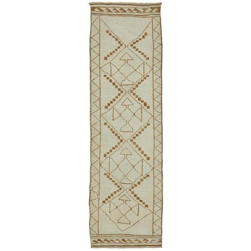 This exquisite runner rug is a rare example of tribal craftsmanship, hand-knotted by the women of the Herki tribe during...