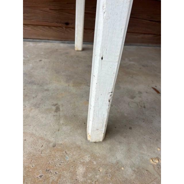 Wooden vintage table. Painted cream on the bottom. Rustic. Square(ish).