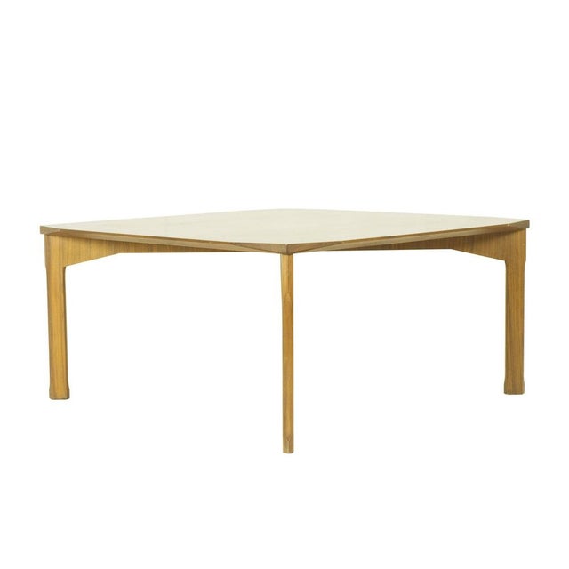 Teak wood coffee table with faceted corners and shaped legs. Very Good condition.