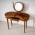 Vanity table crafted from solid walnut, featuring a kidney-shaped top with three drawers and raised on tall, tapering...