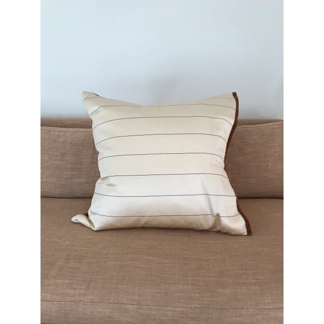 Silk pillow with stylized, art nouveau pattern on front and contrasting pinstripe on back. Single side is edged in velvet...