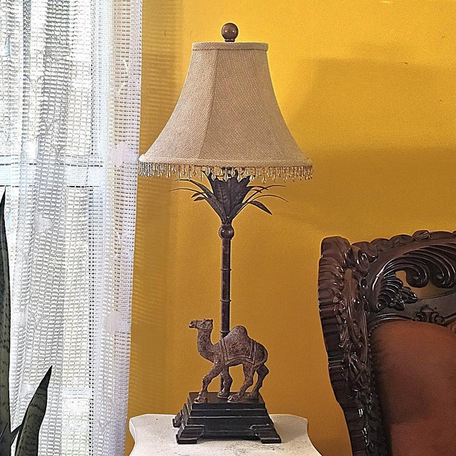 Vintage Berman table lamp featuring a sculpted camel figure on a stepped base with palm-inspired metal detailing and a...