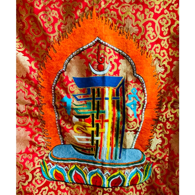 A magnificent example of traditional Buddhist textile art, this stunning "Norbu" (precious jewel) thangka represents both...