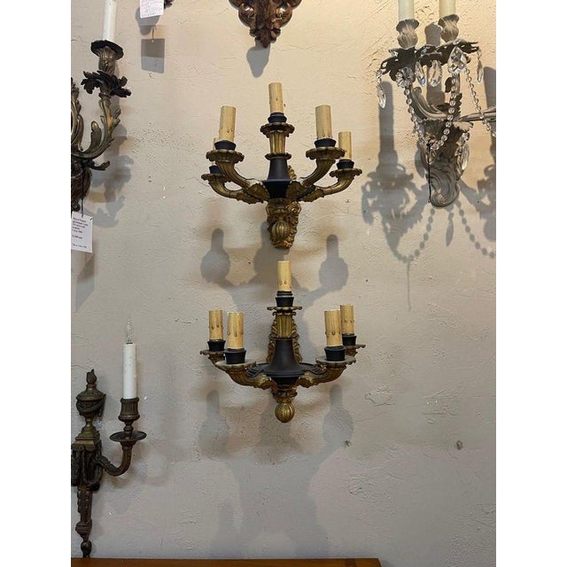 French Empire style pair of gilt bronze sconces with 5 lights. A classic pair in the colors of gold and black. Very nice!.