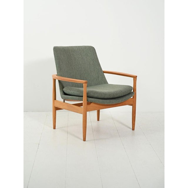 1950s–60s, turned oak and original sage green wool upholstery. Enveloping seat with removable cushion cover. Mid-century...
