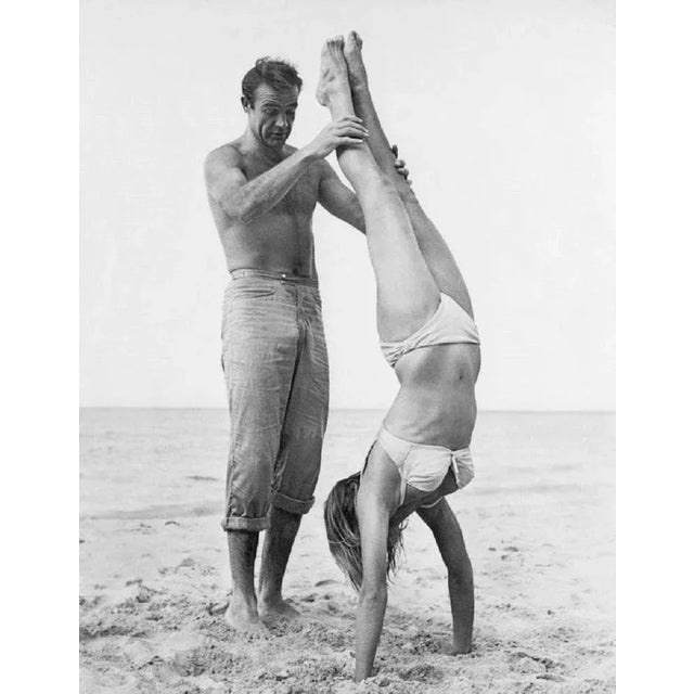 "007 Catches Ursula" by Hulton Archive/Getty Images 1962: Shirtless Scottish actor Sean Connery as James Bond 007 holds...