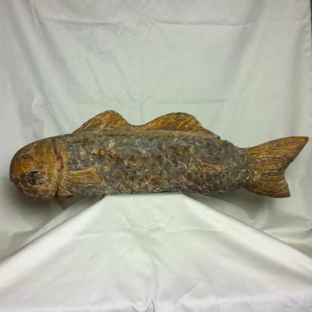 Hand-carved from reclaimed wood, this rustic fish sculpture recreates early 20th-century Chinese folk art designs. The...