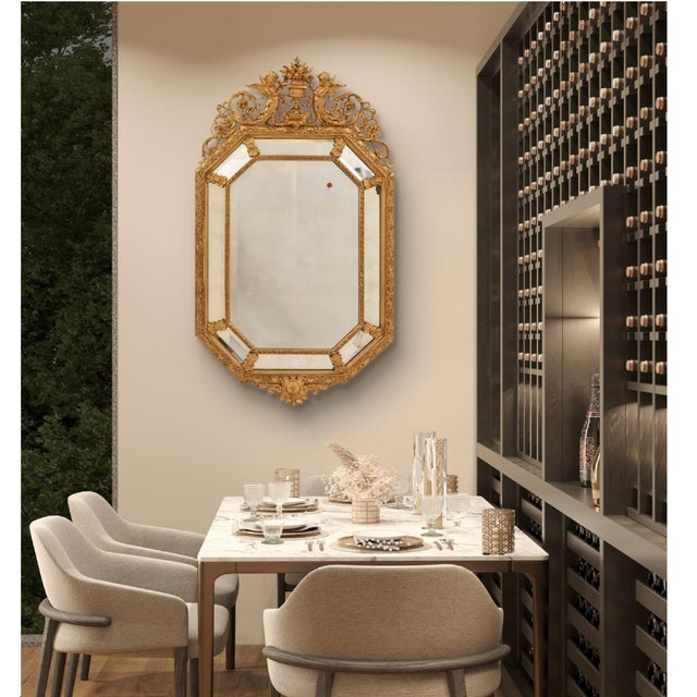 This beautiful antique gilded mirror with crest from the mid-19th century is richly decorated with scrolls, flowers, and...