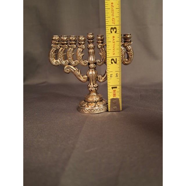 Offered here is an exquisite, finely cast miniature 925 sterling silver Hanukkah Menorah (Hanukkiah). Standing at a highly...