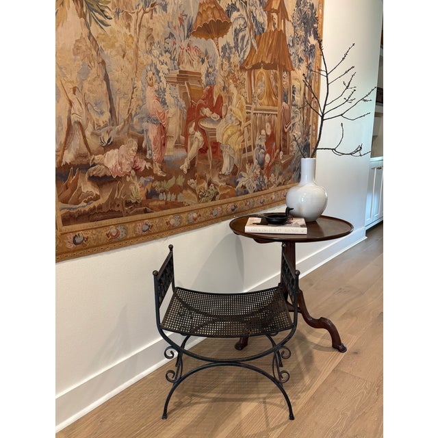 Vintage wrought iron garden stool that could also be used as a vanity stool or alongside a center hall table. Features a...