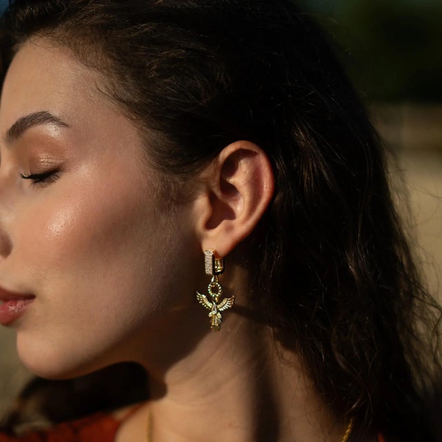 Embody rebirth, strength, and radiant beauty with our Golden Phoenix Drop Earrings. Designed with an elegant phoenix...