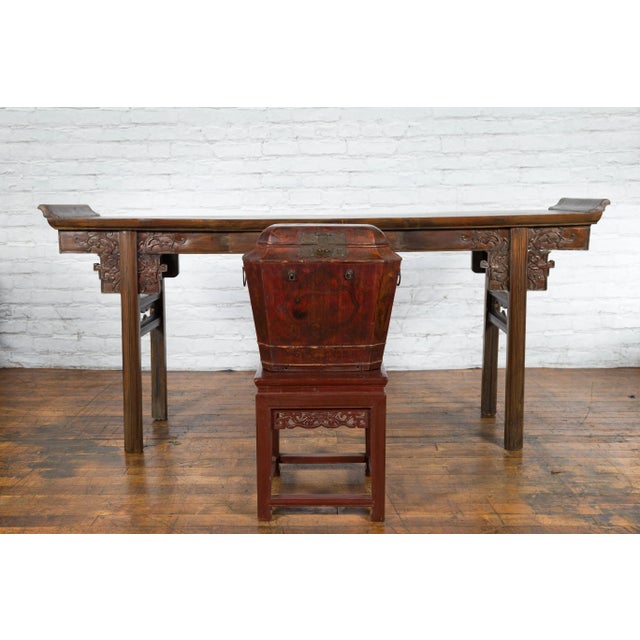 An antique Chinese Qing Dynasty period dark red lacquer wooden wedding chest from the 19th century with unusual shape,...