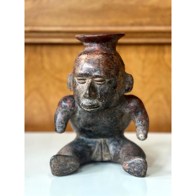 A pre-Columbian figural vessel from West Mexico Colima culture (circa 300BC-400AD). Made of molded clay, the stoneware...