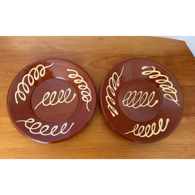 Lovely pair of redware plates, low-fired earthenware with a reddish-brown color and a clear glaze.