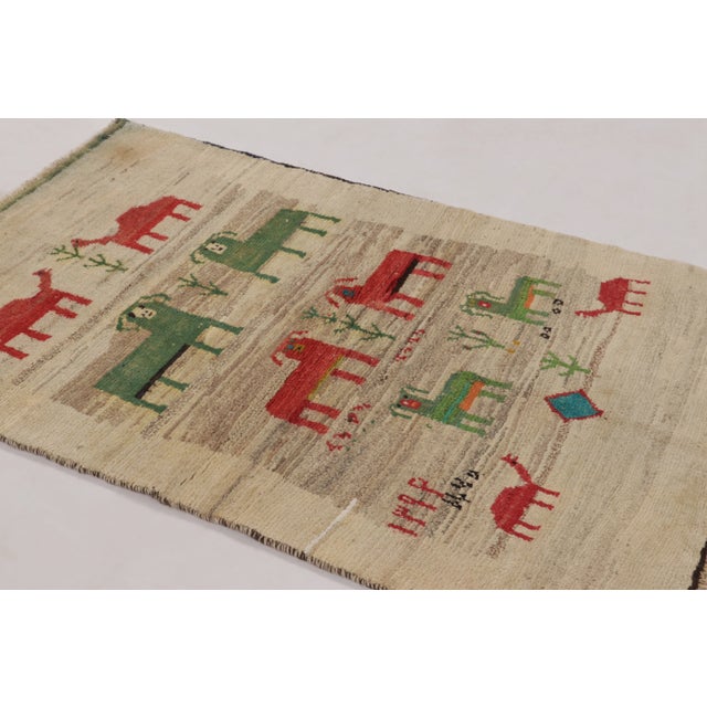 Hand-knotted in wool and originating circa 1950-1959 from Afghanistan, this 4x6 vintage Gabbeh rug joins Rug & Kilim’s...