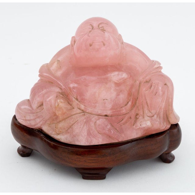 Collection of Seven Chinese Carved Pink Rock Crystal Sculptures, comprising: seated Buddha mounted on ebonized wood base,...