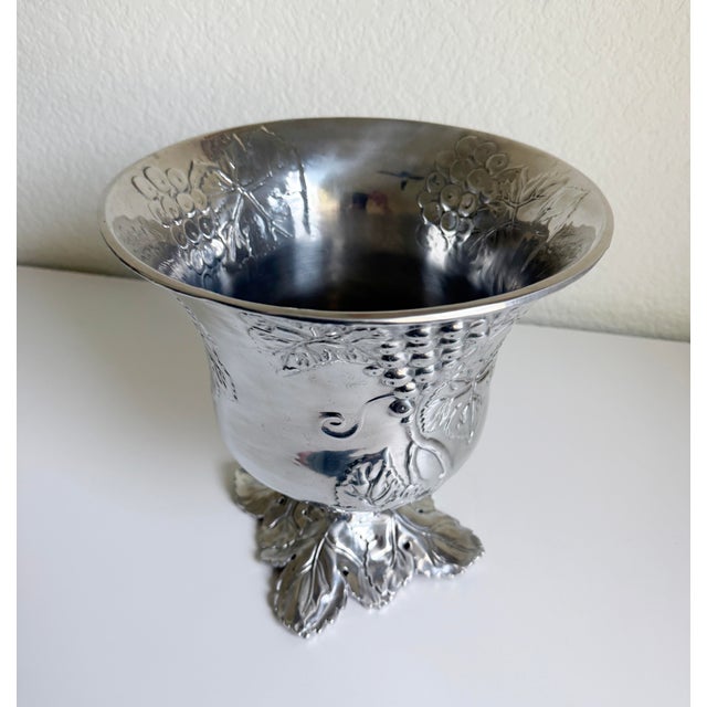 Vintage Arthur Court bottle chiller or ice bucket featuring a polished aluminum-alloy finish with sculpted grape clusters...
