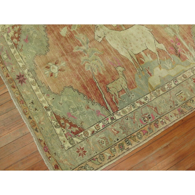 One of a kind hand knotted Turkish Anatolian rug in Pale peach, brown and green accents depicting a large deer, small goat...