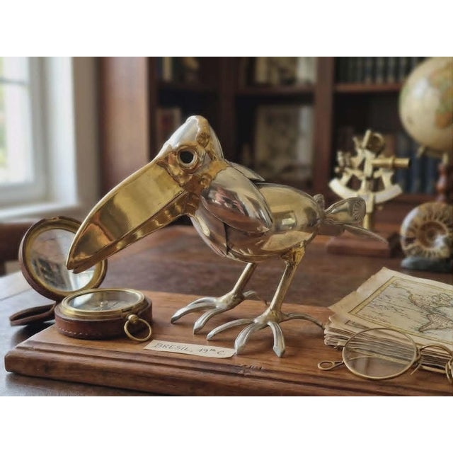 A stylized toucan with fluid and elegant lines, crafted from polished metal that subtly captures the light. The assemblage...