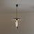 Italian pendant light dating from the 1950s, characterized by a refined mid-century composition in brass, black lacquered...