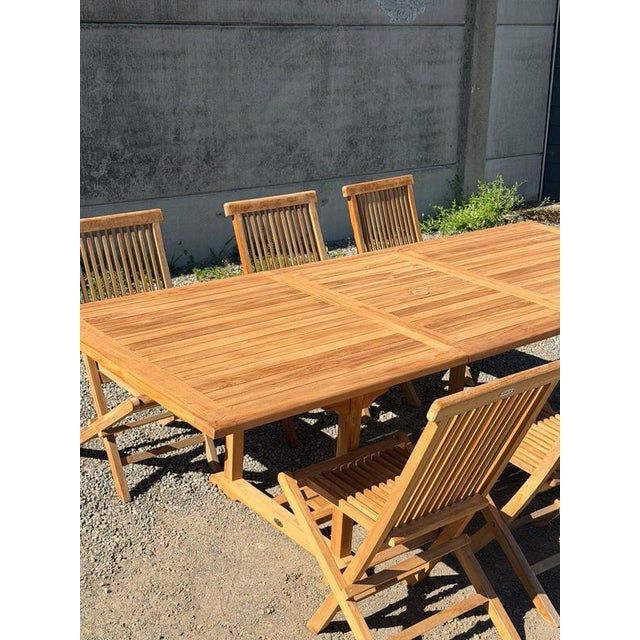 Beautiful solid teak garden dining set consisting of a rectangular extendable table and 6 matching folding chairs. A...