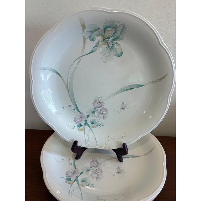 Elegant mid-to-late 20th century dinnerware from Mikasa in the Rondo pattern. Each plate displays a soft watercolor floral...