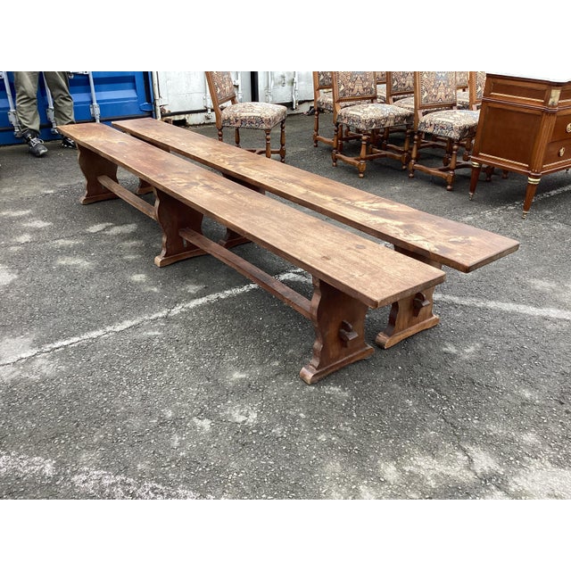 Rare pair of 9 ft long oak benches. These benches are perfect for a farm table and provide lots of seating. Made of French...