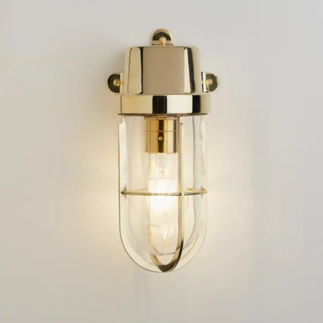 Wall light in solid brass with clear or frosted glass shade. Dimensions: width 123mm - height 259mm - projection 125mm....