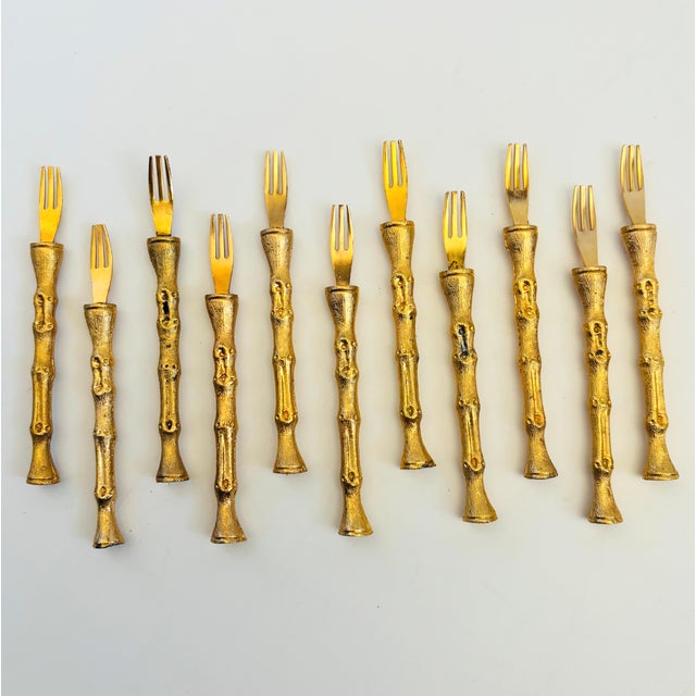 A set of 11 beautiful vintage cocktail forks. Made of metal, each piece has a lovely golden bamboo pattern to the handle...