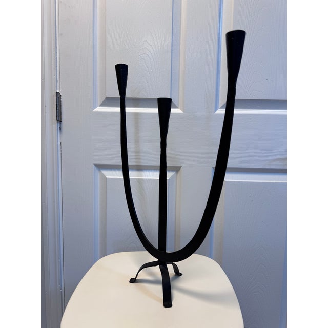 Hand-forged wrought iron candelabra with a Brutalist, Spanish Modern feel. Three asymmetric trumpet-form candle cups,...