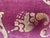 This stenciled velvet pillow by Nomi Textiles is a striking decorative piece, showcasing a luxurious eggplant base with an...