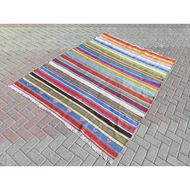 This beautiful, traditional vintage, flatweaved Turkish kilim rug is approximately 60 years old. It is handmade of very...