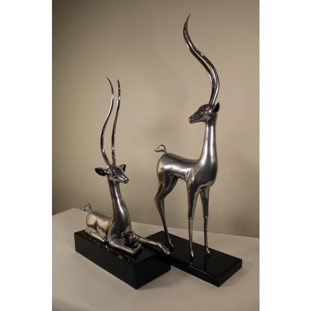 This large pair of Silver-Plated Deer with Tall Antlers and Glossy Black Bases would stun anyone coming into the room....