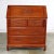 Handsome Asian teak hand carved drop slant front desk with interior compartmentalized cubby storage in the style of George...