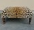George Smith Standard Style Ottoman is in a beautiful leopard velvet fabric with turned mahogany legs on brass casters....
