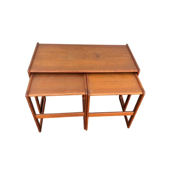 Set of three danish, modern teak, nesting tables with makers mark. This nesting table set was designed by Arne Hovmand -...