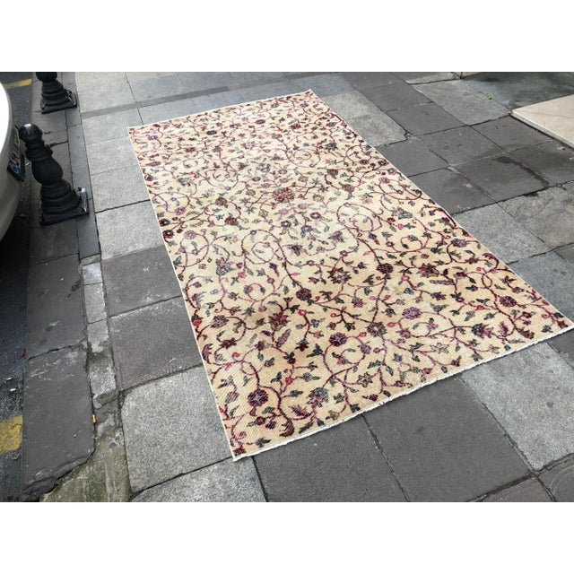 This is a vintage Turkish Oushak rug from the 1960s. The piece was hand-knotted.