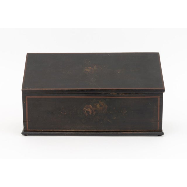American Paint-Decorated and Ebonized Wood Box, 19th century, with hand-painted rose flower details. 6.5" H x 12.5" W x...