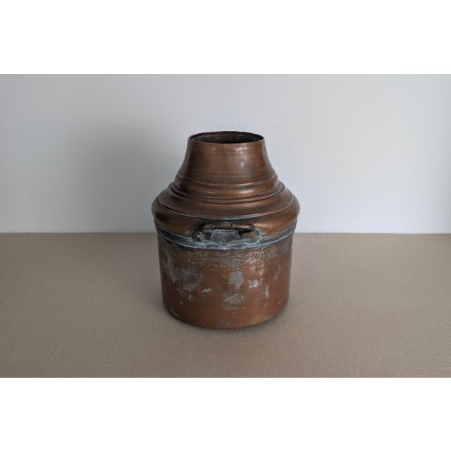 A handsome antique copper dairy vessel, likely dating to the late 19th century, with a cylindrical lower body, stepped and...