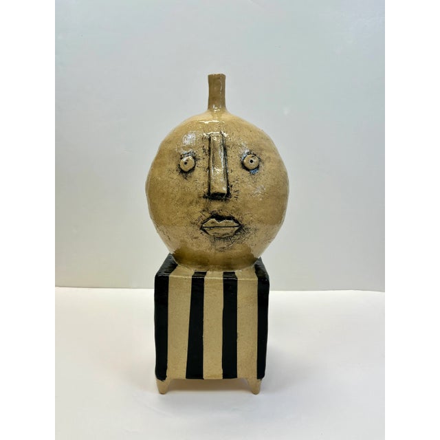 A Picasso inspired decorative room accent signed by artist. A two sided sculpture with faces on both sides.
