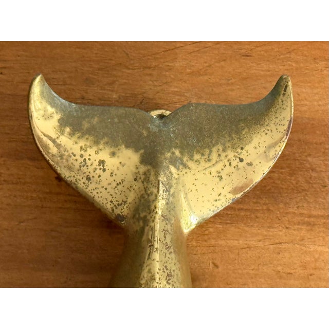 Handsome nautical solid brass whale tale fin door knocker with rustic appeal. Circa 1970s. Please see condition details...