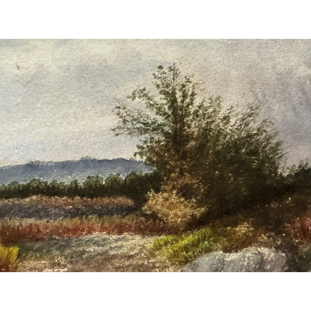 Original watercolor on paper by Frank Henry Mason, depicting a rocky landscape with trees, distant hills, and a dramatic...