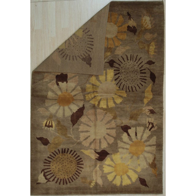 Serene Timeless Brown Hand Knotted Wool Rug, Country of Origin: China. This exquisite hand-knotted wool piece showcases...