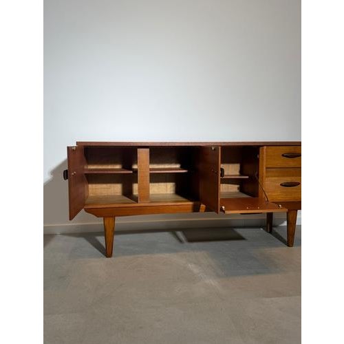 Bring timeless British mid-century style into your home with this elegant teak sideboard by Jentique. Crafted in the...