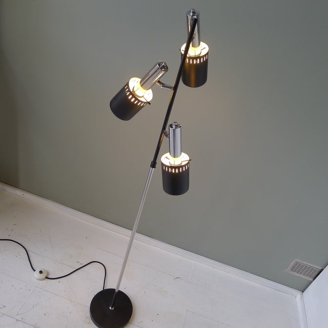Plain floor lamp with adjustable reflectors. These can be rotated and tilted and are each provided with an E27 lamp...