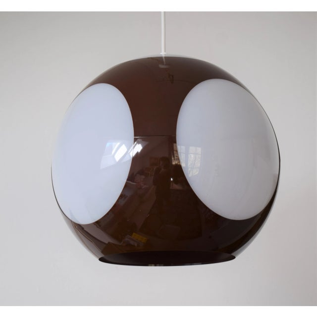 Colani ball lamp from the 70s in intense brown with milk glass-colored plastic inserts. This lamp is also `flying eye. She...
