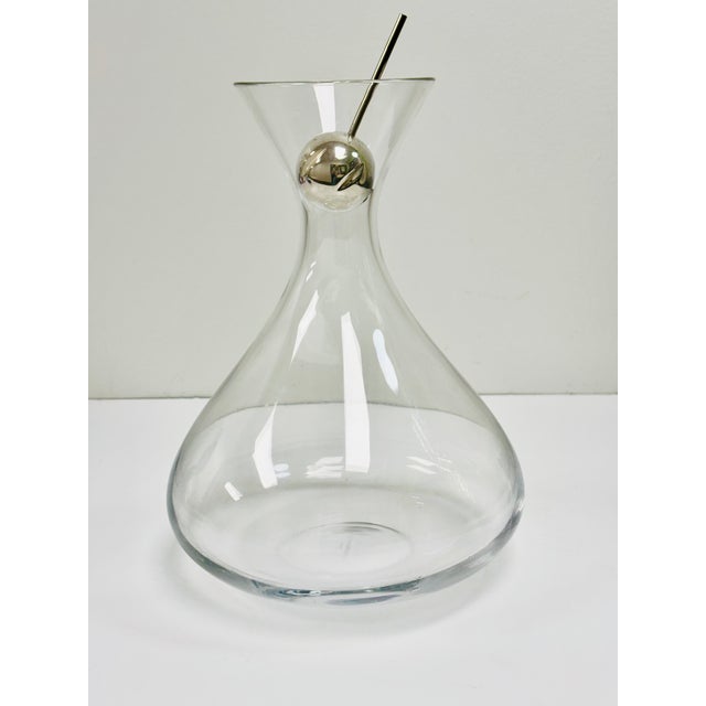 An elegant mouth-blown glass decanter paired with the Developer®: a patented wine pourer that enhances oxygenation,...