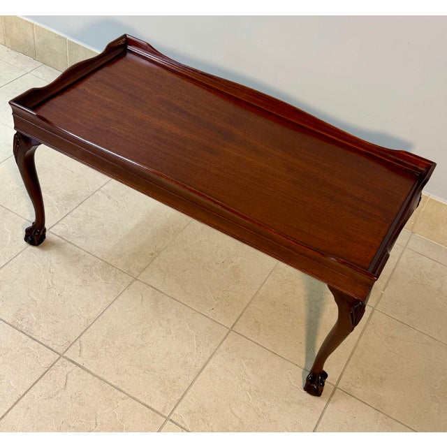 Elegant Chippendale style mahogany tea table. Raised wavy gallery border, cabriole legs with carved leaf knees and ball...